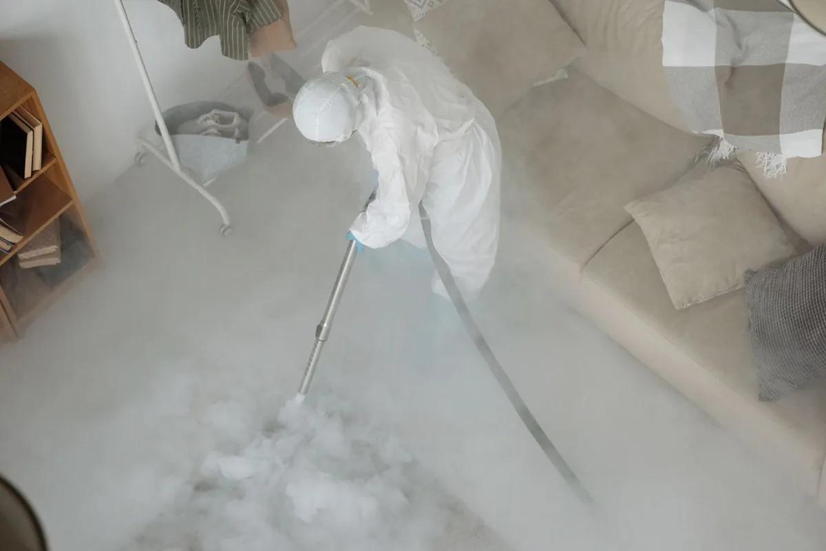 Biohazard cleanup technician in protective equipment, Monroe City, MO
